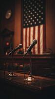 Courtroom Setup With Microphones and American Flag in the Background Before a Legal Proceeding photo