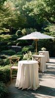 Outdoor Garden Setup With Tables and Flowers for a Special Event in a Serene Atmosphere. photo