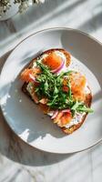 Delicious Brunch Dish Featuring Eggs, Smoked Salmon, and Greens on Toasted Bread. photo