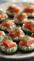 Cucumber Rounds Topped With Cream Cheese and Smoked Salmon Garnished With Fresh Dill at a Food Gathering photo