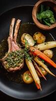 Gold Crusted Lamb Chops With Root Vegetables and Herbs Served on a Black Plate photo