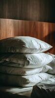 Soft White Pillows Stacked Against a Wooden Wall in Warm Afternoon Light. photo