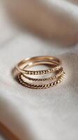 Elegant Gold Rings Stacked on Soft Fabric Showcasing Intricate Designs and Textures photo