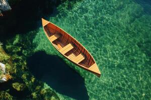 Wooden Boat Floating on Clear Turquoise Water in a Peaceful Coastal Area. photo