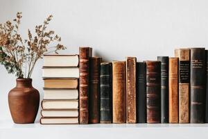 Classic Books Lined up on a Shelf With a Minimalist Background. photo