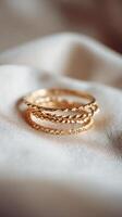Elegant Gold Rings Stacked on Soft Fabric Showcasing Intricate Designs and Textures. photo