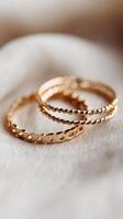 Elegant Gold Rings Resting on Soft Fabric Showcase Timeless Accessory Style and Design. photo