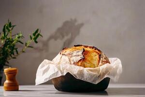 Freshly Baked Artisan Bread on a Marble Surface With Decorative Elements Nearby photo