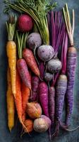 Fresh Assorted Root Vegetables Arranged on a Textured Background in Vibrant Colors photo