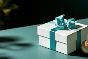 Elegant Gift Box With Teal Ribbon on a Smooth Grey Surface Showcasing Perfect Wrapping. photo