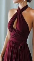 Elegant Burgundy Dress Showcasing Unique Design During an Indoor Fashion Event photo