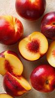 Freshly Sliced Peaches and Whole Peaches Arranged on a Light Surface for a Delicious Snack photo