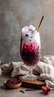 Beautifully Layered Beverage With Ice and Floral Accents Presented on a Rustic Table photo