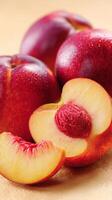 Freshly Sliced Peaches and Whole Peaches Arranged on a Light Surface for a Delicious Snack. photo