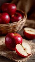 Fresh Red Apples on Burlap Fabric With a Sliced Apple Showing Juicy Interior and Seeds. photo