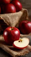 Fresh Red Apples on Burlap Fabric With a Sliced Apple Showing Juicy Interior and Seeds photo