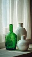 Beautiful Collection of Glass Vases Displayed Near a Window in Soft Natural Light photo