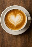 A cup of coffee with a heart shape in the foam photo