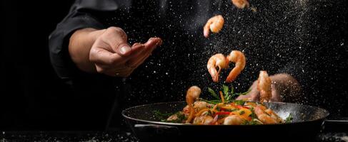 The chef skillfully prepares shrimp in a modern kitchen with flair and precision. photo