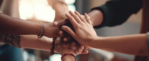 The hands united in a show of teamwork and collaboration among diverse individuals. photo