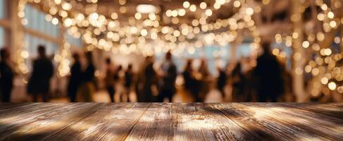 The wooden table with blurred party lights in the background creating ambiance. photo