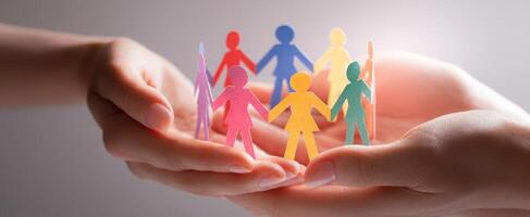 The colorful paper figures symbolize unity and support in a caring community. photo