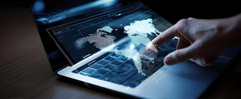The laptop featuring a futuristic interactive world map on its touchscreen. photo