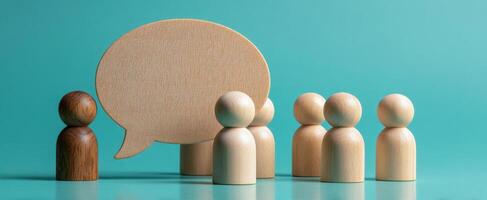 The wooden figures engaging in a dialogue about ideas and teamwork. photo