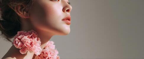The elegant woman adorned with pink flower accessories in soft lighting. photo