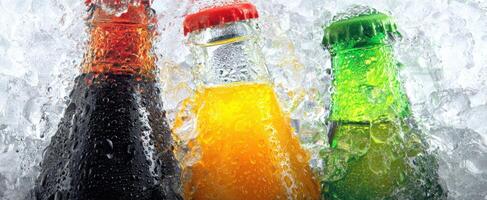 The Refreshing Bottles of Colorful Beverages Nestled in Ice photo
