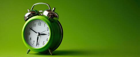 The vibrant green alarm clock with metallic accents on a solid backdrop. photo