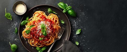 The vibrant plate of spaghetti served with fresh basil and tomato sauce photo
