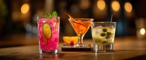 The assortment of vibrant cocktails on a rustic wooden table. photo