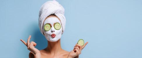 The woman enjoying a refreshing spa treatment with a facial mask and cucumber slices. photo