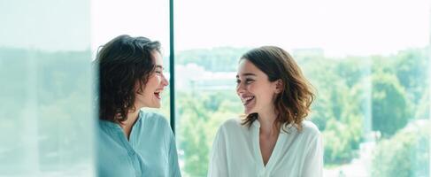 The joyful moment between two friends enjoying a light-hearted conversation by the window. photo