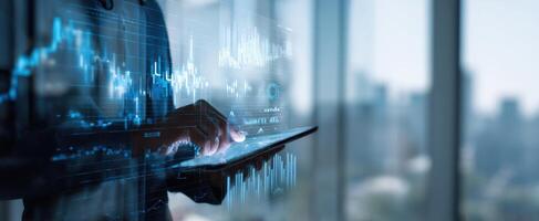 The financial analyst interacting with digital data on a tablet device. photo
