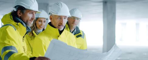 The construction team reviews blueprints for successful project planning and execution. photo