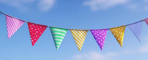 The colorful bunting flags hanging against a bright blue sky. photo