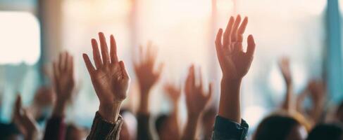 The hands of an engaged audience raising for questions and participation. photo