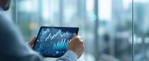 The tablet displaying financial analytics in a modern office environment. photo