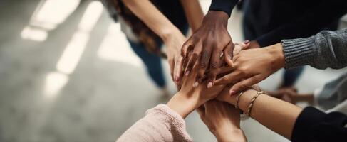 The hands of diverse individuals coming together in a display of unity and support photo