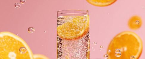 The refreshing orange drink with bubbles and vibrant colors in glass photo