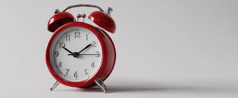 The vintage red alarm clock displaying classic timekeeping features and style. photo