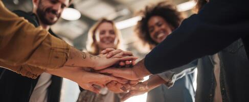 The group of diverse people celebrating teamwork and unity with hands stacked together. photo