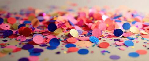 The colorful confetti scattered across a surface for festive celebrations. photo