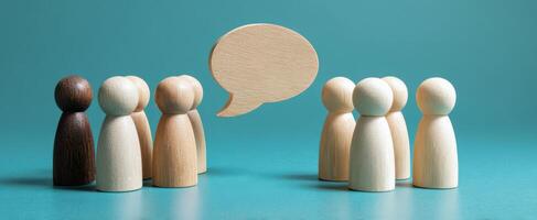 The wooden figures engaging in a meaningful conversation about teamwork and ideas. photo