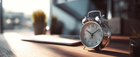 The vintage alarm clock on a wooden desk in a bright workspace photo