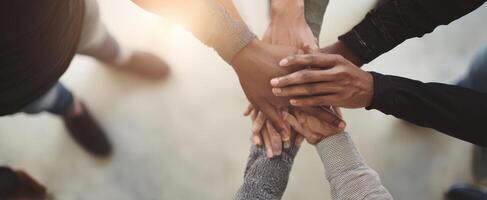 The hands of unity representing teamwork and support among diverse individuals. photo