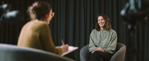 The smiling woman engaged in a thoughtful interview setting. photo