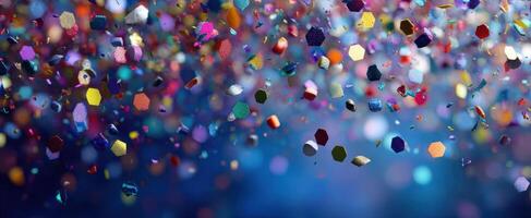 The Colorful Confetti Falling Against a Dark Blue Background photo